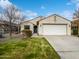 Single-story home with a two-car garage and well-manicured lawn at 41876 W Corvalis Ln, Maricopa, AZ 85138
