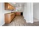 Modern kitchen with wood cabinets and laminate flooring at 41876 W Corvalis Ln, Maricopa, AZ 85138