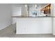 Kitchen features a breakfast bar and wood cabinets at 41876 W Corvalis Ln, Maricopa, AZ 85138