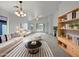 Bright and airy living room with comfortable seating and built-in shelving at 41876 W Corvalis Ln, Maricopa, AZ 85138