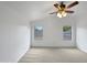 Spacious main bedroom with two windows and a ceiling fan at 41876 W Corvalis Ln, Maricopa, AZ 85138