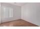 Simple bedroom with wood-look flooring and window at 4233 E Colonial Dr, Chandler, AZ 85249