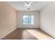 Simple bedroom with wood flooring and ceiling fan at 4233 E Colonial Dr, Chandler, AZ 85249