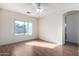 Bright bedroom with wood flooring, ceiling fan, and window at 4233 E Colonial Dr, Chandler, AZ 85249