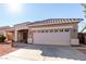 House exterior featuring tan walls, tile roof, and a two-car garage at 4233 E Colonial Dr, Chandler, AZ 85249