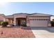 One-story house with tan exterior, tile roof, and a two-car garage at 4233 E Colonial Dr, Chandler, AZ 85249