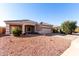 Tan house with tile roof, two-car garage, and desert landscaping at 4233 E Colonial Dr, Chandler, AZ 85249