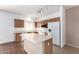 Open kitchen with island, wood cabinets, and stainless steel appliances at 4233 E Colonial Dr, Chandler, AZ 85249