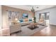 Bright living room with hardwood floors, comfy seating, and large windows at 4233 E Colonial Dr, Chandler, AZ 85249