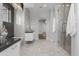 Modern bathroom with marble walls and glass shower at 6237 N 5Th Pl, Phoenix, AZ 85012