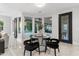 Breakfast nook with glass table and black chairs, overlooking the pool at 6237 N 5Th Pl, Phoenix, AZ 85012