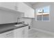 Modern laundry room with white cabinets and gray countertops at 6237 N 5Th Pl, Phoenix, AZ 85012