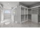Spacious walk-in closet with white built-ins and marble floors at 6237 N 5Th Pl, Phoenix, AZ 85012