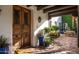 Inviting courtyard entry with terracotta tile and wooden doors at 6617 N Central Ave, Phoenix, AZ 85012