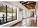 Bright hallway with terracotta tile floors and views to a courtyard at 6617 N Central Ave, Phoenix, AZ 85012