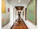 Long hallway with tile flooring and artwork on the walls at 6617 N Central Ave, Phoenix, AZ 85012