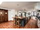 Spacious kitchen boasts a large island with seating, custom cabinetry, and terracotta tile floors at 6617 N Central Ave, Phoenix, AZ 85012