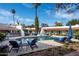 Inviting pool with lounge chairs, surrounded by a beautiful patio and lush landscaping at 6617 N Central Ave, Phoenix, AZ 85012