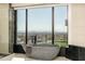 Luxury bathroom featuring a freestanding tub with city views at 7147 N 23Rd Pl, Phoenix, AZ 85020