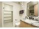 Contemporary bathroom with marble vanity, floating shelves, and a walk-in closet at 7147 N 23Rd Pl, Phoenix, AZ 85020