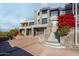 Modern home with stone exterior, red flowers, and a long driveway at 7147 N 23Rd Pl, Phoenix, AZ 85020