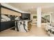 Open concept kitchen with marble island, modern appliances, and game room view at 7147 N 23Rd Pl, Phoenix, AZ 85020