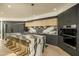 Modern kitchen with marble island and dark grey cabinetry at 7147 N 23Rd Pl, Phoenix, AZ 85020