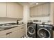 Modern laundry room with marble countertops, ample cabinetry, and a stylish sink at 7147 N 23Rd Pl, Phoenix, AZ 85020