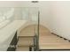 Modern staircase with glass railings and light wood treads at 7147 N 23Rd Pl, Phoenix, AZ 85020