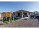 Backyard view showing patio, playset, and house exterior at 7332 W Quail Track Dr, Peoria, AZ 85383