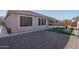 Home exterior and grassy backyard with playset at 7332 W Quail Track Dr, Peoria, AZ 85383