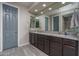 Bathroom with double vanity, granite countertop, and large shower at 7332 W Quail Track Dr, Peoria, AZ 85383