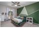 Bedroom with metal bed frame and green accent wall at 7332 W Quail Track Dr, Peoria, AZ 85383