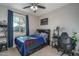 Bedroom with double bed, desk, and window with curtains at 7332 W Quail Track Dr, Peoria, AZ 85383