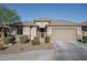 Single-story home with a two-car garage and well-manicured landscaping at 7332 W Quail Track Dr, Peoria, AZ 85383