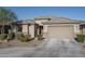 Tan two-story house with a two-car garage at 7332 W Quail Track Dr, Peoria, AZ 85383
