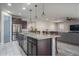 Modern kitchen with island, stainless steel appliances, and ample cabinet space at 7332 W Quail Track Dr, Peoria, AZ 85383