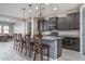 Modern kitchen with dark cabinets, granite counters, and an island at 7332 W Quail Track Dr, Peoria, AZ 85383