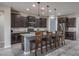 Modern kitchen with dark cabinets, granite counters, and an island at 7332 W Quail Track Dr, Peoria, AZ 85383