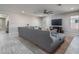 Spacious living area with sectional sofa and a large TV at 7332 W Quail Track Dr, Peoria, AZ 85383