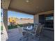 Covered patio with table and chairs, overlooking backyard at 7332 W Quail Track Dr, Peoria, AZ 85383