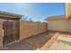 Small backyard with block wall and gated access at 8908 W Loma Ln, Peoria, AZ 85345