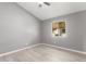 Simple bedroom with wood-look floors and a window providing natural light at 8908 W Loma Ln, Peoria, AZ 85345