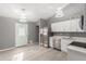 Bright kitchen with stainless steel appliances and white cabinets, opens to dining area at 8908 W Loma Ln, Peoria, AZ 85345