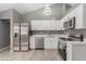 Remodeled kitchen with white cabinets, stainless steel appliances, and quartz countertops at 8908 W Loma Ln, Peoria, AZ 85345