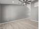 Spacious living room with grey walls and ceiling fan at 8908 W Loma Ln, Peoria, AZ 85345
