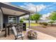 Covered patio with firepit and seating area, overlooking a grassy backyard at 8938 N 15Th Ln, Phoenix, AZ 85021