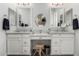 Double vanity bathroom with marble countertops and large mirrors at 8938 N 15Th Ln, Phoenix, AZ 85021