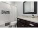Bathroom with a shower/tub combo, granite countertop, and dark brown vanity at 8938 N 15Th Ln, Phoenix, AZ 85021