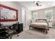 Bright bedroom with a queen bed, desk, and window coverings at 8938 N 15Th Ln, Phoenix, AZ 85021